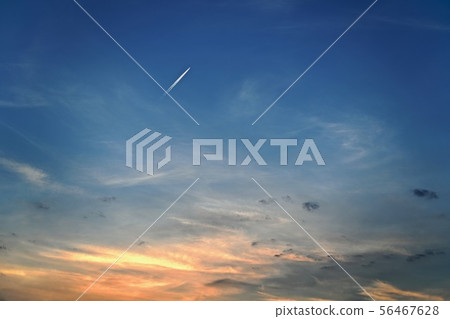 The plane flies at sunset in cirrus clouds. 56467628