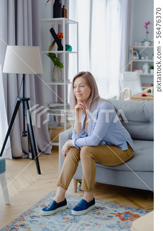 Young happy blonde woman in cozy interior Young happy blonde woman in cozy interior 56476370