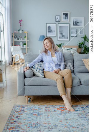 Young happy blonde woman in cozy interior Young happy blonde woman in cozy interior 56476372