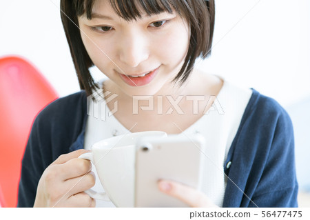 Coffee break woman smartphone 56477475