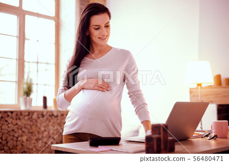 Pretty young girl demonstrating her abdomen on camera Pretty young girl demonstrating her abdomen on camera 56480471