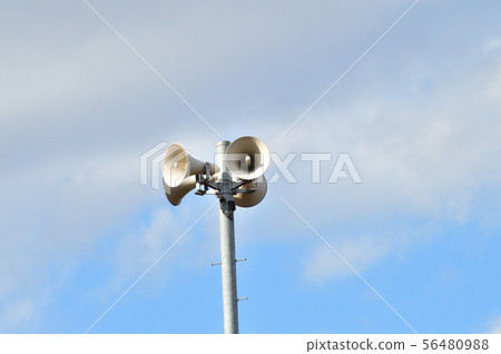 Photo taken at low angle of four outdoor speakers attached to the column Photo taken at low angle of four outdoor speakers attached to the column 56480988