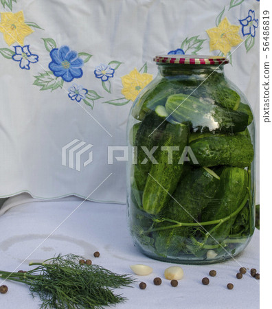 Pickled cucumbers in glass jar. Pickled cucumbers in glass jar. 56486819
