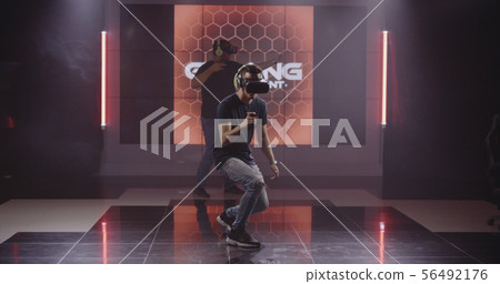 Young men playing VR game 56492176