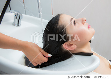 woman wash their hair in a beauty salon woman wash their hair in a beauty salon 56493122