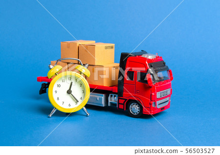 A truck with cargo cardboard boxes and a yellow 56503527