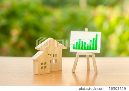 Two wooden houses and a green good positive trend 56503529