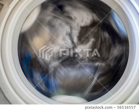 Top loading washing machine washes laundry. 56516557