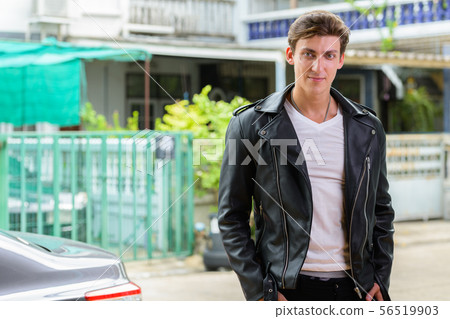 Portrait of young handsome rebellious man outdoors Portrait of young handsome rebellious man outdoors 56519903