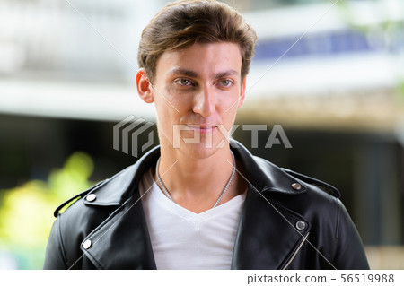 Face of young handsome rebellious man thinking outdoors Face of young handsome rebellious man thinking outdoors 56519988