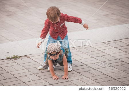 Cute little brothers at summer day playing and smiling Cute little brothers at summer day playing and smiling 56529922
