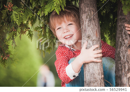Cute little boy at summer day playing and smiling Cute little boy at summer day playing and smiling 56529941