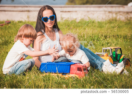 happy family young mother and sons spending time outdoor on a summer day 56530005