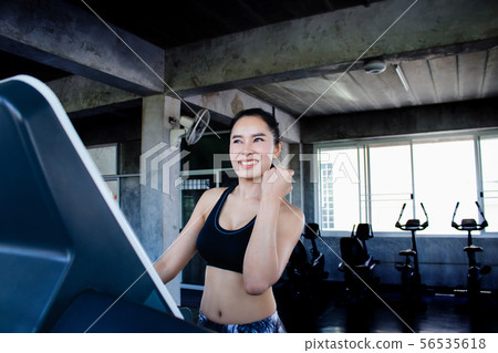 Asian woman happy with workout at gym Asian woman happy with workout at gym 56535618