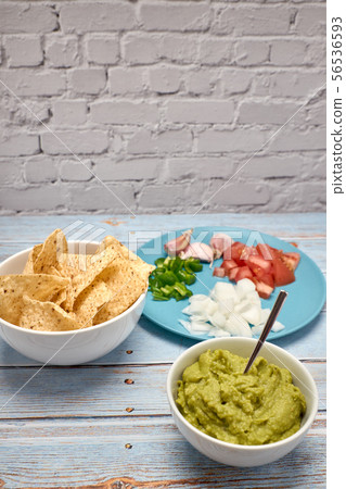 view of a bowl with spicy guacamole next to a bowl view of a bowl with spicy guacamole next to a bowl 56536593