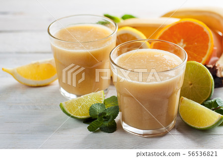 Banana and citrus fruits smoothie or milkshake 56536821