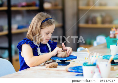 Child at pottery wheel. Kids arts and crafts class 56542937