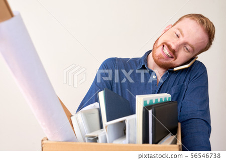 Businessman carrying box of belongings Businessman carrying box of belongings 56546738