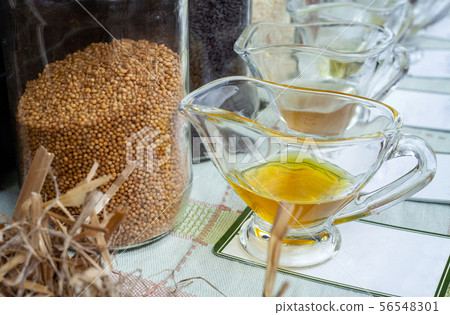 Mustard seeds in jar and oil pressed from them. Mustard seeds in jar and oil pressed from them. 56548301