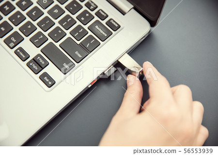 Woman's hand connects design aluminium pendrive Woman's hand connects design aluminium pendrive 56553939