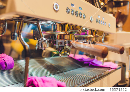 Close-up of an espresso machine making a cup of coffee. Close-up of an espresso machine making a cup of coffee. 56571232