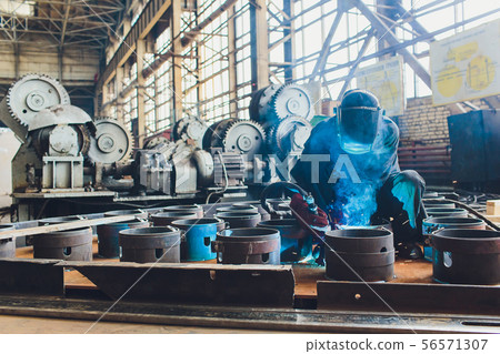 man factory interior, worker and cnc machine. 56571307