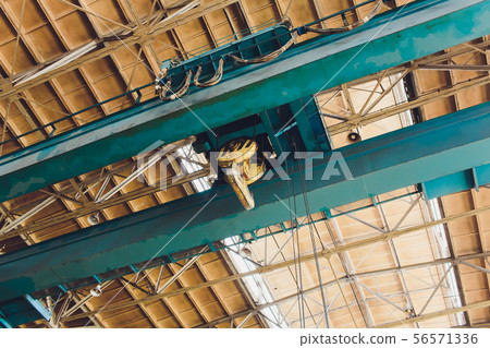 Crane chain and hook blurred warehouse background with remote control. Concept production steel Crane chain and hook blurred warehouse background with remote control. Concept production steel 56571336