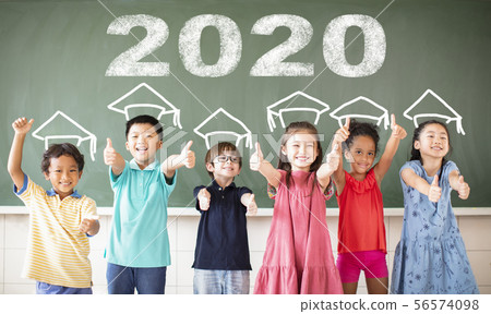 Multi-ethnic group of school children standing in 56574098