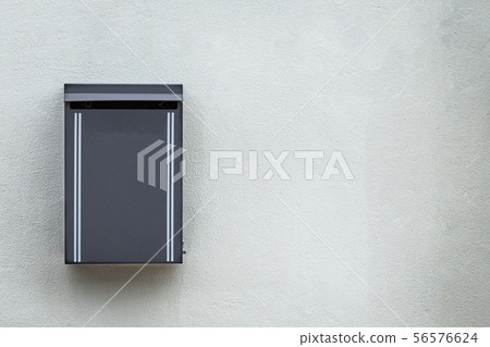Gray metal mailbox mounted on the cement wall Gray metal mailbox mounted on the cement wall 56576624