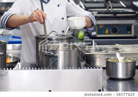 Chef tastes food. Kitchen utensils, plate with Chef tastes food. Kitchen utensils, plate with 56577820