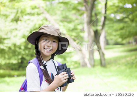 Elementary school girl doing bird watching 56580120