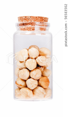 Hazelnuts in a glass bottle with cork stopper, isolated. Hazelnuts in a glass bottle with cork stopper, isolated. 56583502