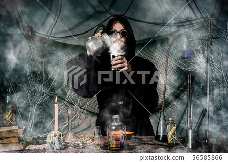 The medieval alchemist make magic ritual at the 56585866