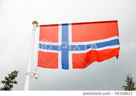 flag of Norway on a flagstuff in front of the sky 56588621