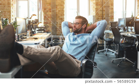 Work done. Side view of satisfied bearded young man in eyeglasses and formal wear holding hand 56589159