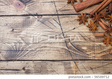 Cinnamon sticks and anise stars on wooden backgrou Cinnamon sticks and anise stars on wooden backgrou 56589712