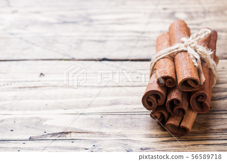 A few cinnamon sticks tied with thread and anise A few cinnamon sticks tied with thread and anise 56589718