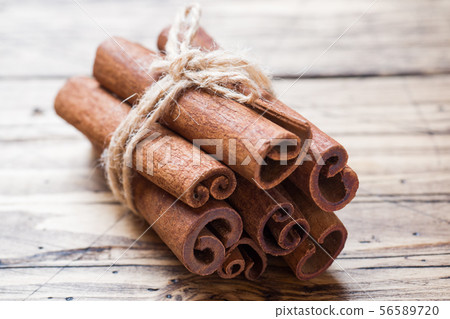 A few cinnamon sticks tied with thread and anise A few cinnamon sticks tied with thread and anise 56589720
