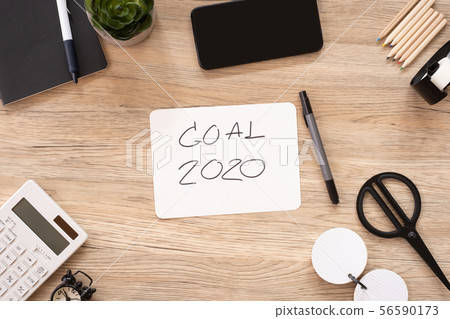 new year goal 2020 on paper top view at wood 56590173