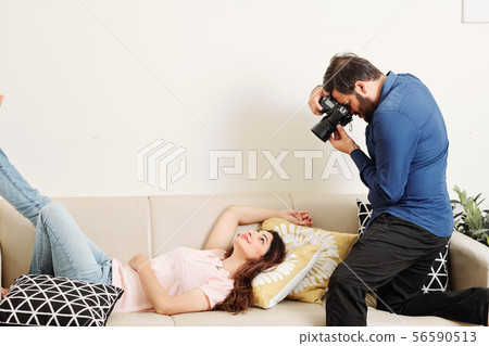 Young woman posing for photographer 56590513