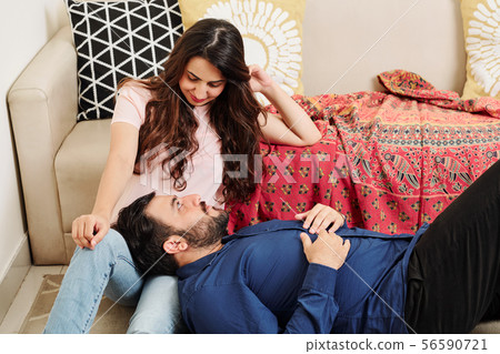 Indian couple resting at home Indian couple resting at home 56590721
