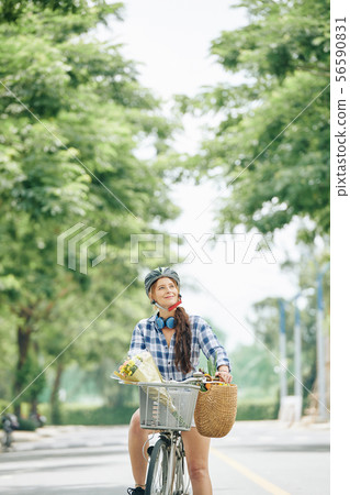 Happy woman riding bicycle Happy woman riding bicycle 56590831