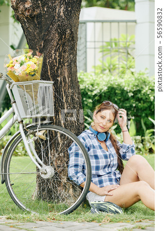 Woman resting under tree Woman resting under tree 56590832