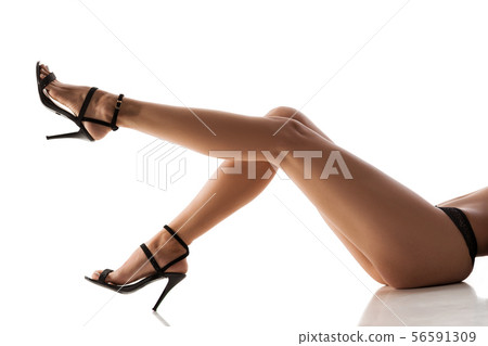 woman legs in black high heel shoes 56591309