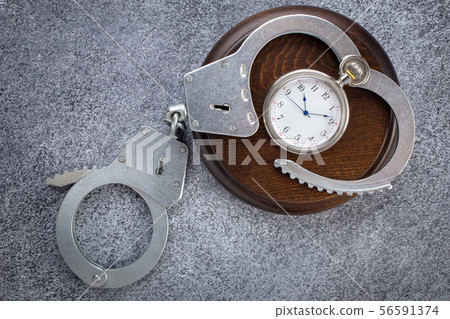 Open handcuffs with pocket watch 56591374