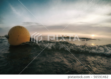Yellow buoys on water waves. Sea at sunset. 56591462