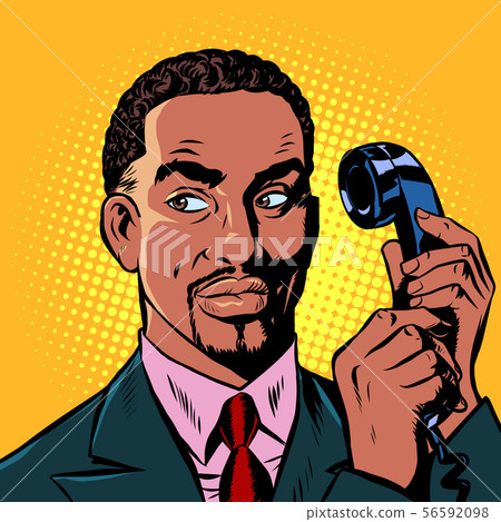 serious african man talking on a retro phone 56592098