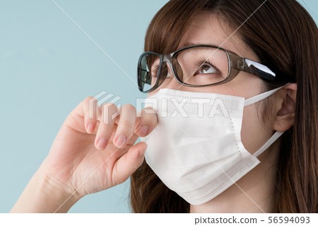 Woman with hay fever, put on goggles 56594093