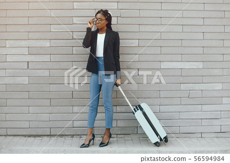 Elegant black girl in a summer city 56594984