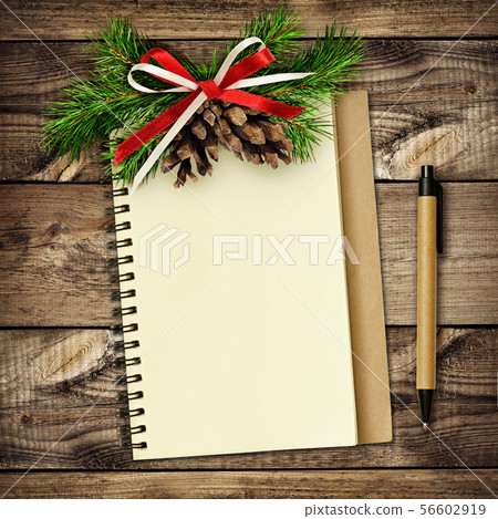 Notebook and pen with Christmas decorations on 56602919